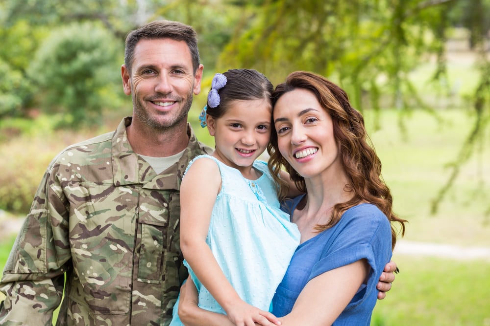 Handsome soldier reunited with family on a sunny day